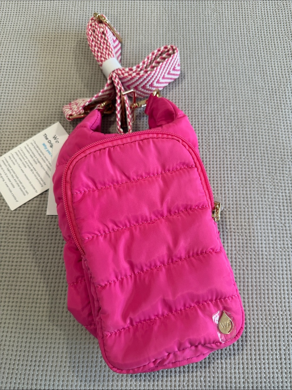 Hot Pink Quilted Shoulder Bag with Chevron Strap carries a 32 ounce water bottle